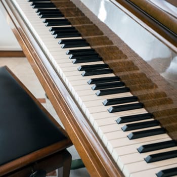 Old piano. Cropped shot of classical piano in a room with natural light.