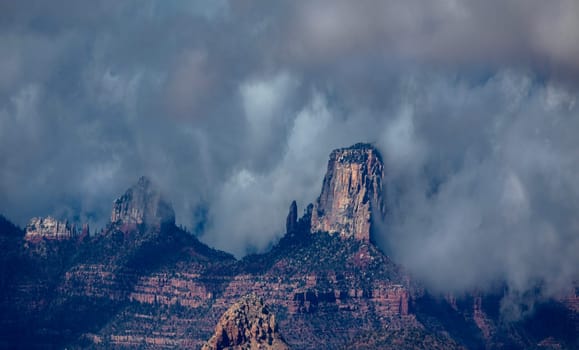 Passing rain storm produces clouds that filter the sunlight at Grand Canyon National Park, Arizona