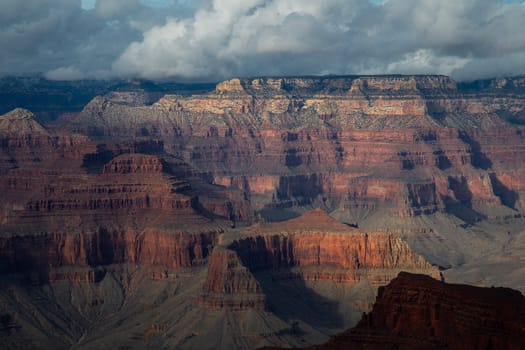 Passing rain storm produces clouds that filter the sunlight at Grand Canyon National Park, Arizona