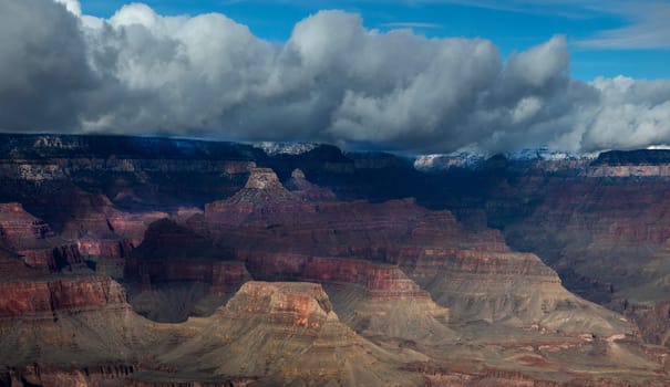 Passing rain storm produces clouds that filter the sunlight at Grand Canyon National Park, Arizona