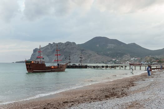 Sailing ship sailing to the shore, marine tourism. Beach holidays on the Black Sea. Fabulous moments of a sunny day