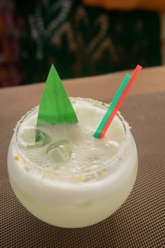 Cold coconut cocktail in a low glass glass. The concept of cold summer drinks.