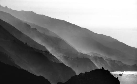 Mornig fog and mist have eveloped the cliffs along the beach  at the Pacific Ocean at Big Sur, California.