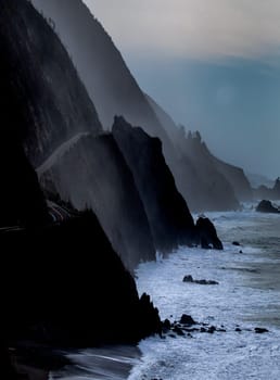 Powerful waves crash upon the beach along Pacific Coast Highway at the Pacific Ocean at Big Sur, California.