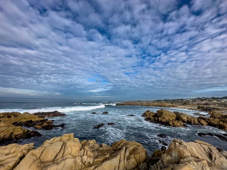 Powerful waves crash upon the beach along the Pacific Ocean at Monterey, California