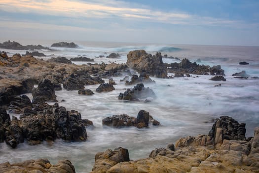 Powerful waves crash upon the beach along the Pacific Ocean at Monterey, California