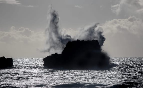 Powerful waves crash upon the beach along the Pacific Ocean at San Simeon, California