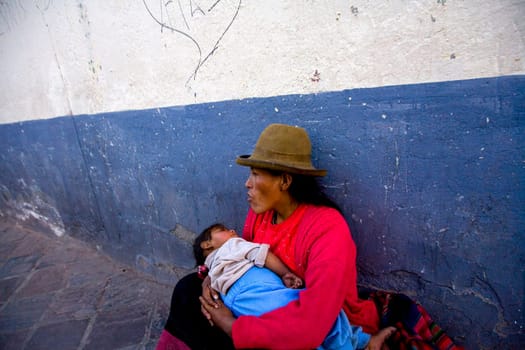 MOTHER HANDLES NEWBORN IN ALLEY IN CUZCO, PERU