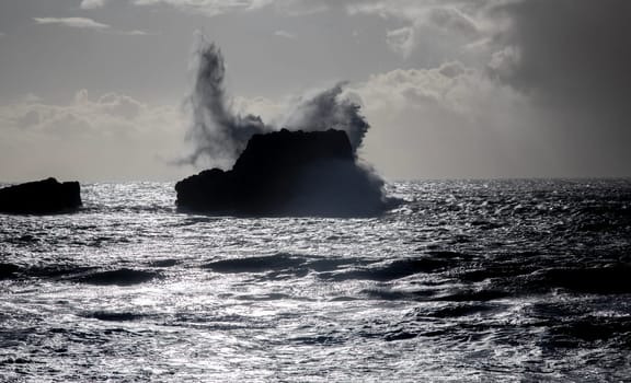 Powerful waves crash upon the beach along the Pacific Ocean at San Simeon, California