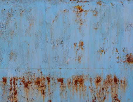 faded blue paint on flat sheet steel surface with stains of rust - full-frame background and texture.