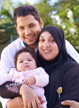 Muslim, park and portrait of parents with child for bonding, ramadan and outdoors together. Islam, happy family and mother, father and newborn infant for love, childcare and support in nature.