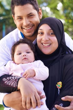 Muslim, park and portrait of parents with baby for bonding, ramadan and outdoors together. Islam, happy family and mother, father and newborn infant for love, childcare and support in garden.