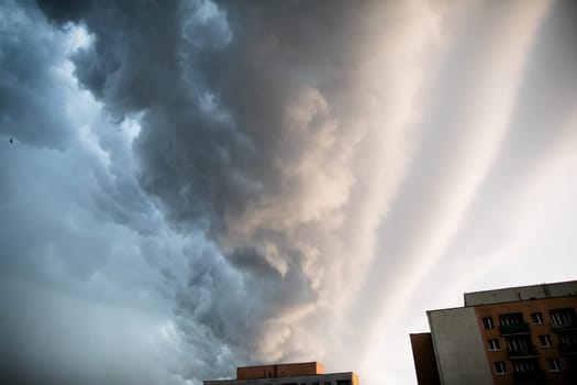 A local hurricane rages over city skyscrapers. The sky is covered with clouds.