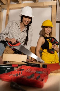 A brunette with a braid and a blonde with short hair are waiting for the start of a new job on the construction site.