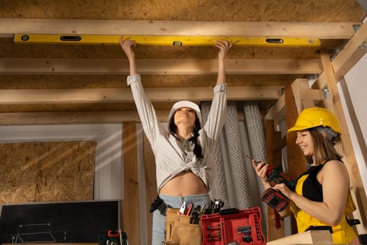 Level control by an engineer in a white protective helmet. The blonde is watching how the work is being commissioned.