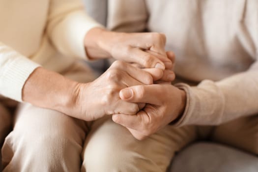 An intimate capture of two people holding hands, symbolizing support, comfort, and a strong bond between them