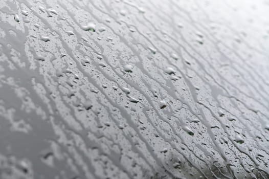 Raindrops on the side window of a car on an autumn day 1