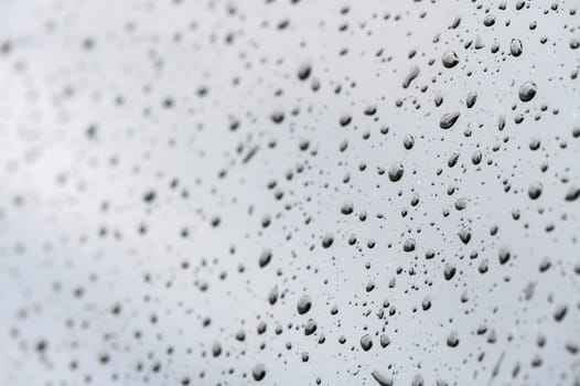 Rainy day, water droplets on car window's side mirror.1