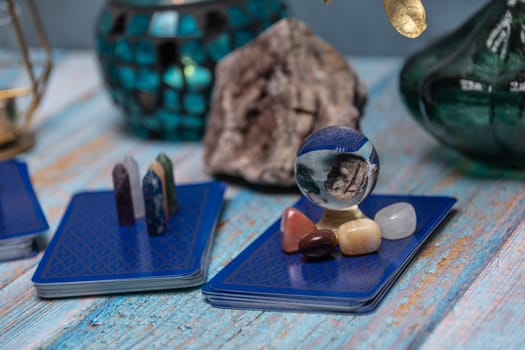 A tarot card reading setup with an array of colorful healing crystals on a weathered wooden table, invoking a sense of mysticism