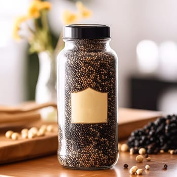 A jar of black pepper sits on a table next to a bowl and a plant. The jar is empty and has a label on it