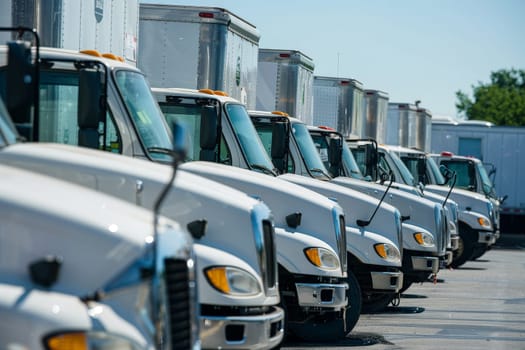 low angle photo of a fleet of box trucks in a car park, New truck fleet transportation.