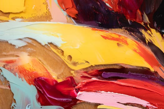 Fragment of multicolored texture painting on plywood. Abstract art background. oil on canvas. Rough brushstrokes of paint. Closeup of a painting by oil and palette knife. Highly-textured, high quality details.