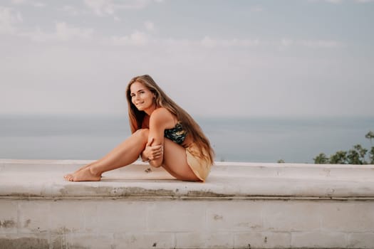 Woman park yoga. Side view of free calm bliss satisfied woman with long hair standing in morning park with yoga position against of sky by the sea. Healthy lifestyle outdoors in park, fitness concept