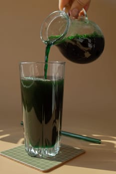 Organic blue-green algae spirulina detox drink in glass powder food. Health protein cocktail smoothie of chlorella. Vitamins and minerals to diet. Prebiotic and antioxidant rich Dietary supplement Seaweed superfood concept