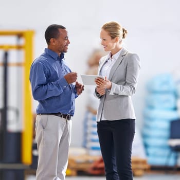 Business people, warehouse and smile with tablet for planning, supply chain and logistics export. Woman, man and digital technology with meeting for teamwork, collaboration and storage in factory.