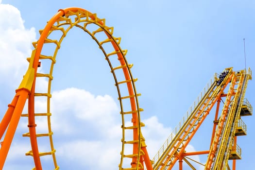 close-up image of a roller coaster track and the blue sky