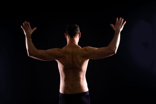 Portrait of man, bodybuilder and bicep flex in a studio, background and exercise for muscular power.