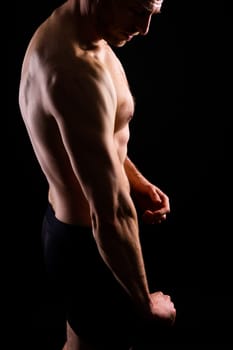 Portrait of man, bodybuilder and bicep flex in a studio, background and exercise for muscular power.