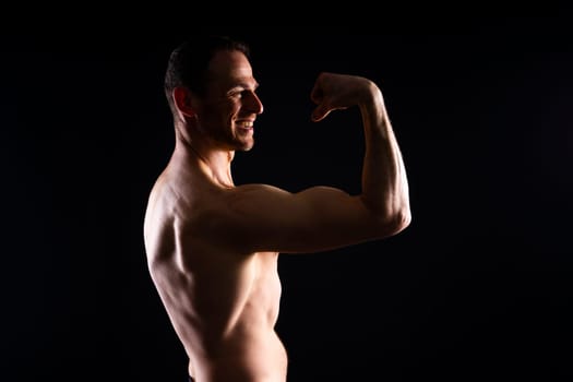 Portrait of man, bodybuilder and bicep flex in a studio, background and exercise for muscular power.