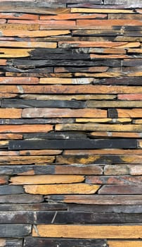 Vertical Wall constructed with stacked stone slabs, abstract background. High quality photo