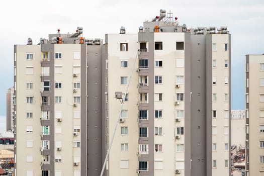 Home removal with hydraulic lift. Transporters carrying goods by elevator from the window of the building