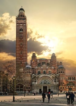 London, United Kingdom - February 02, 2019: People walking in front of Westminster Cathedral on cold day with nice afternoon clouds. It's the main catholic church in England and Wales consecrated 1910