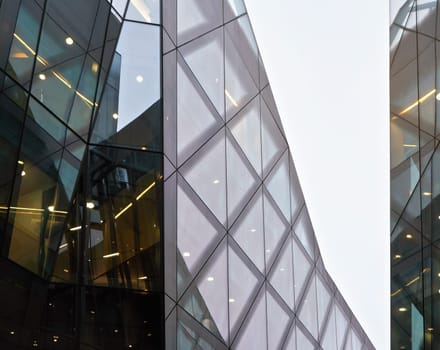 London, United Kingdom - February 02, 2019: Rectangular windows on One New Change shopping mall - modern glass and steel building designed by Jean Nouvel, overcast sky background