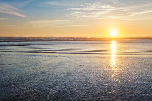 Atlantic ocean sunset with surging waves at Fonte da Telha beach, Costa da Caparica, Portugal