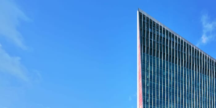 London, United Kingdom - February 02, 2019: Regular rectangular windows on The Nova Building - modern glass and steel architecture designed by Benson + Forsyth, clear blue sky background