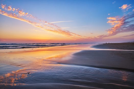 Atlantic ocean after sunset with surging waves at Fonte da Telha beach, Costa da Caparica, Portugal