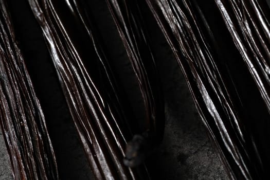 Vanilla beans on dark gray board - abstract close up macro detail with shallow depth of field