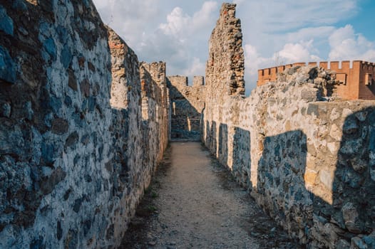 Fortress ruins of the historical Red Tower - Kizil Kule, in Alanya Castle. The Red Tower is the symbol of the Alanya city, and the famous touristic place, Turkey (Turkiye).