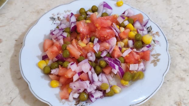 fresh vegetable salad, onions, peas and tomato, corn . High quality photo