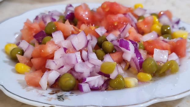 fresh vegetable salad, onions, peas and tomato, corn . High quality photo