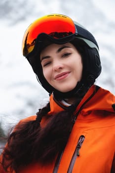 A young woman of Caucasian ethnicity looks to the side and smiles, raising her head to the sky, enjoying her vacation at the ski resort