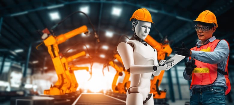 XAI Mechanized industry robot and human worker working together in future factory. Concept of artificial intelligence for industrial revolution and automation manufacturing process.