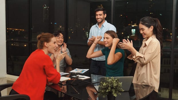 Businesspeople putting hands together and clapping hands to celebrate successful project at modern office with night city view. Group of manager with stacks of hands. Teamwork, trust. Tracery