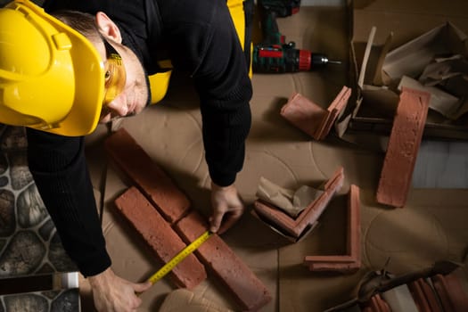 While measuring with a pull-out measure, a manual worker found time to smile and enjoy the job he is doing.