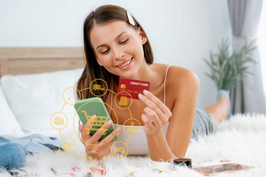 Customer lying down wearing white tank top holding credit card typing phone choose online platform. Smart consumer opening e-commerce application use cashless technology shopping inventory. Cybercash.