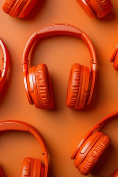 A set of orange headphones highlighted on an orange background.